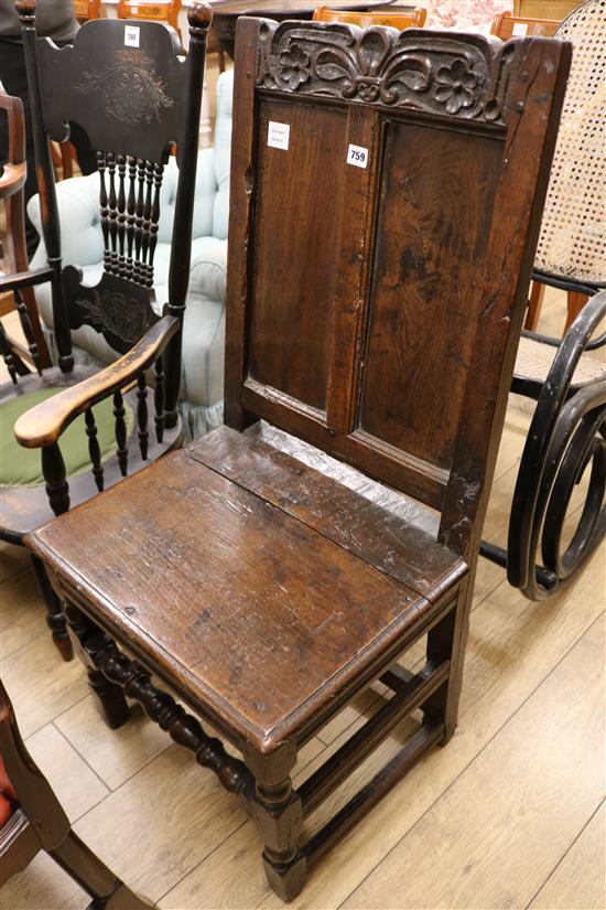A 17th century panelled oak back stool